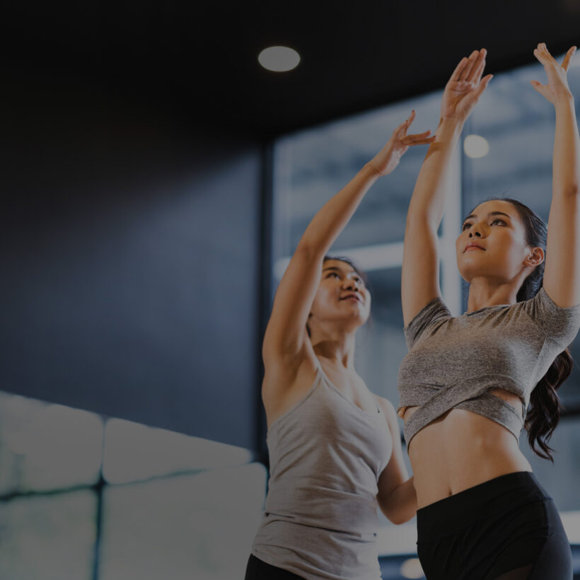 Two women practicing exercises in a dance studio, demonstrating their skills and enthusiasm for dance